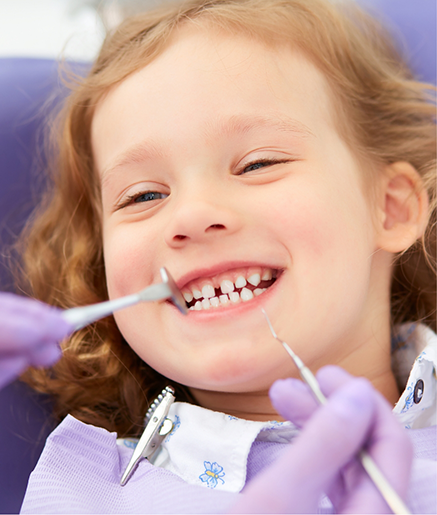 Young girl grinning during her dental appointment