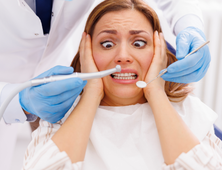 Patient in dental chair looking terrified